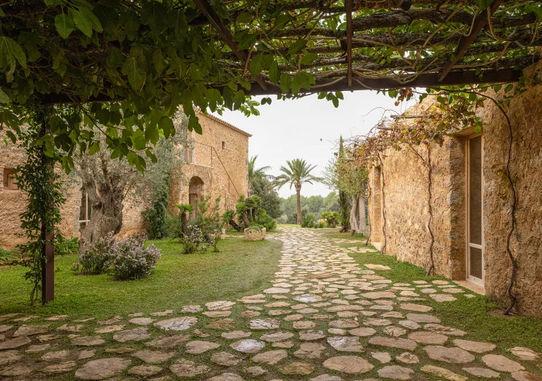 Stone alleyway between two orange, stone buildings