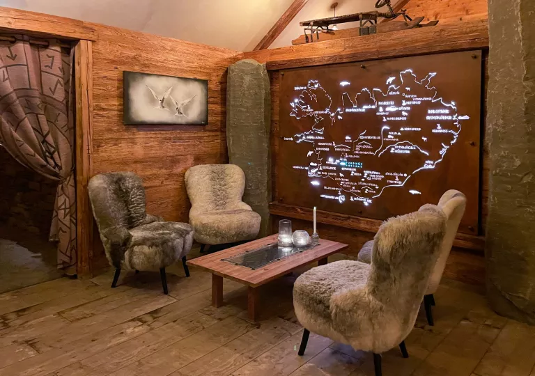 fur covered chairs around a table with a map on the wall