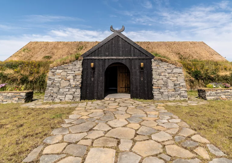 cobblestone path leading to black barn door