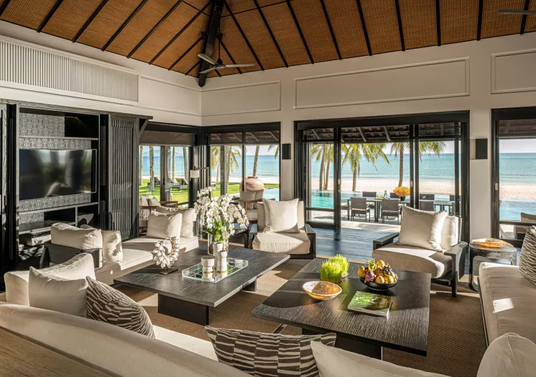 large living room with couches surrounding coffee tables