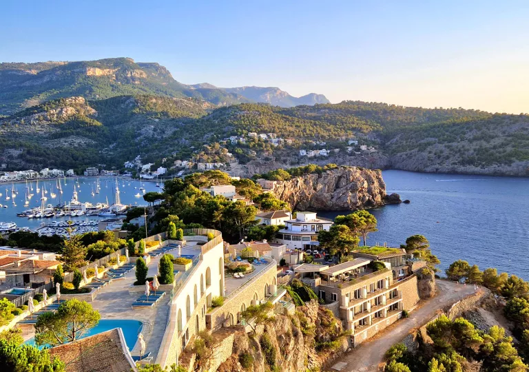 Exterior, skyview of hotel building with rooftop patios and a lake on the right