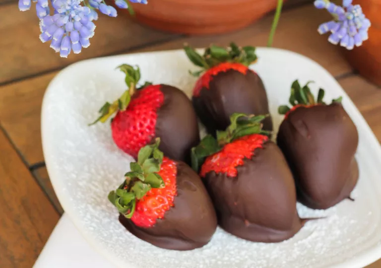 Chocolate covered strawberries on a white plate
