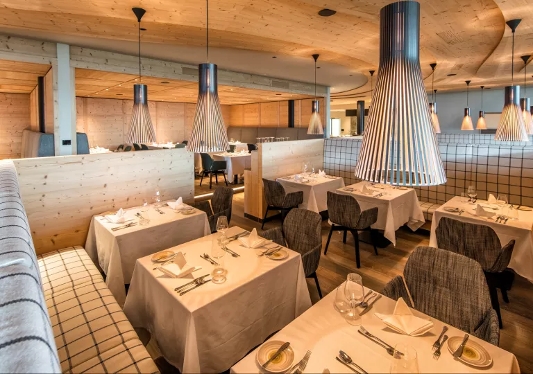 Indoor dining area with gray cushioned chairs and black light fixtures