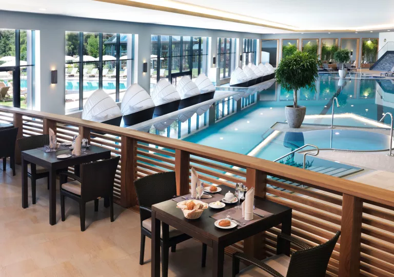 pool surrounded by chairs and tables