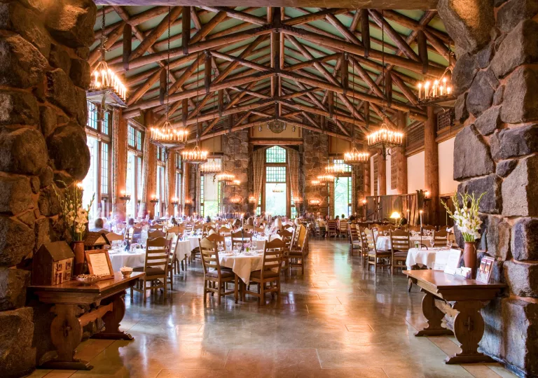 Indoor dining hall with tall wooden and stone pillars