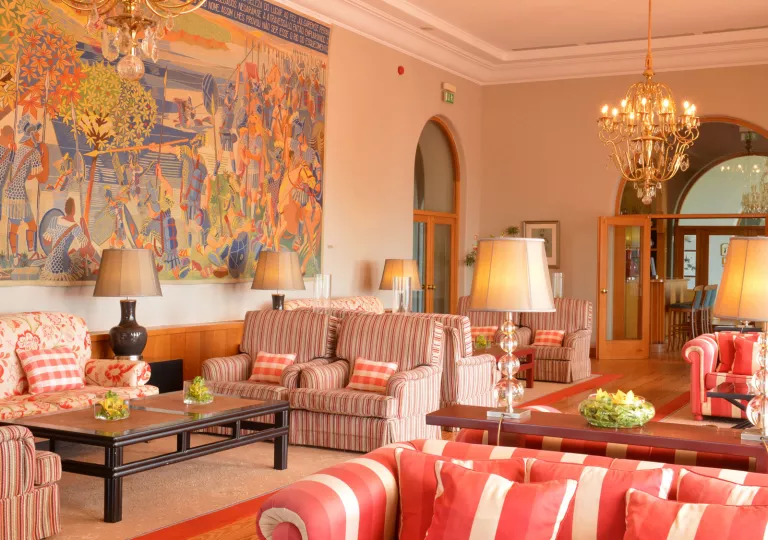 Red and white cushioned chairs in a hotel lobby