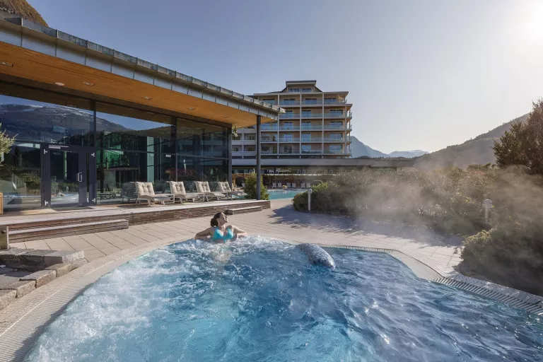 Women in a bubbling hot tub looking out to the mountains