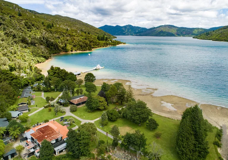 Coastline of a small beach  leadings towards smaller buildings