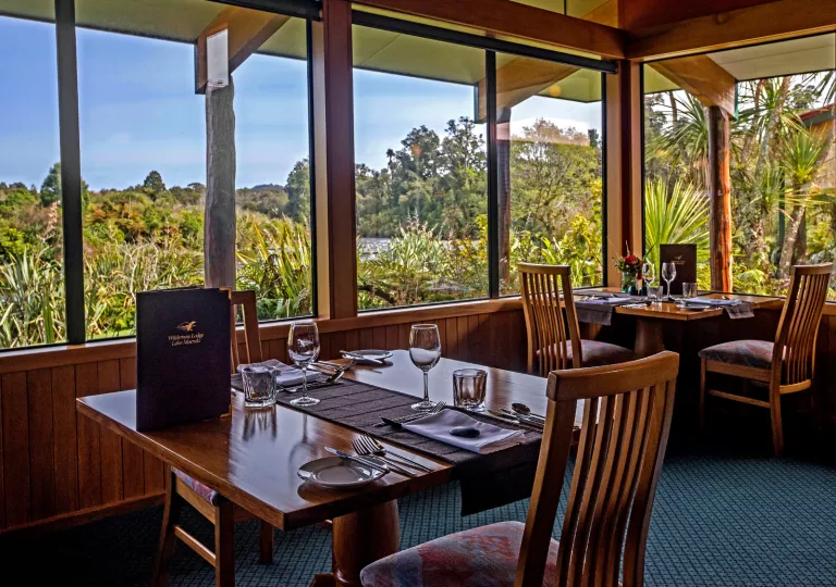 Dining room with wooden chairs and tables, and a menu on the table