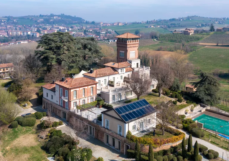 Exterior sky view of stone and brick buildings with an outdoor pool