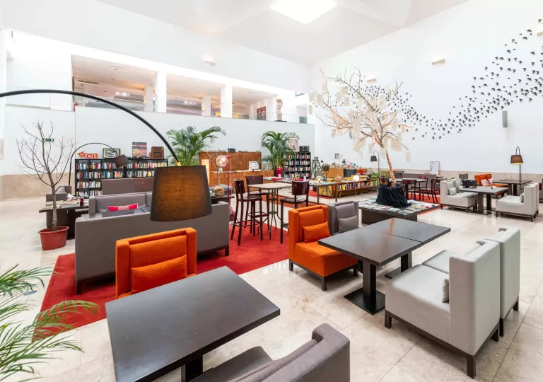 lobby with bookshelves and chairs and couches