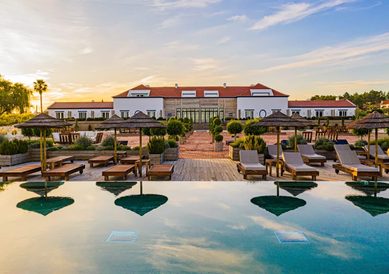 Front view of hotel with an infinity pool in front