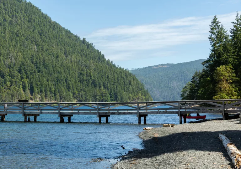 Wooden bridge over a lake and a gravel coast