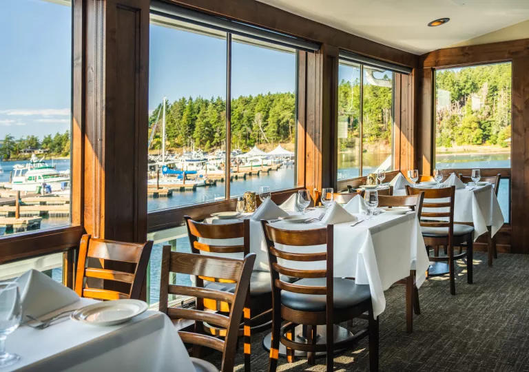 Indoor dining room with table cloths and wine glasses on each table