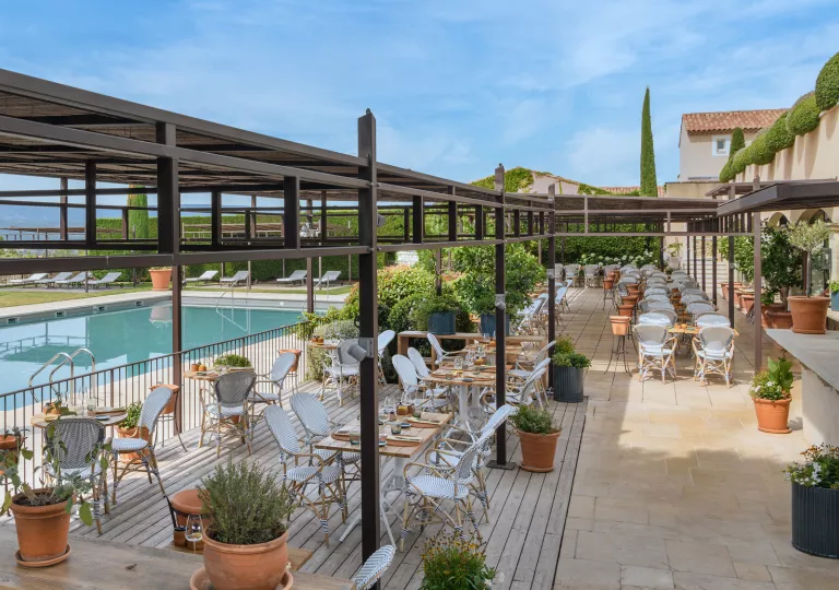 Outdoor dining patio next to a pool