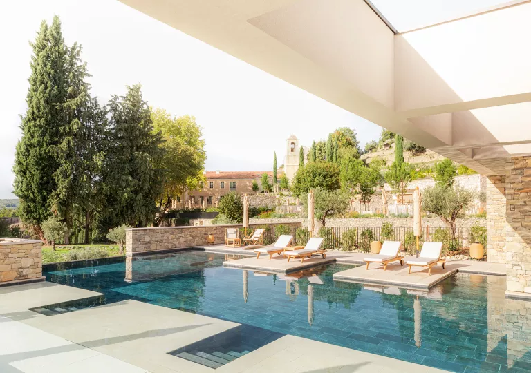 outdoor pool surrounded by lounge chairs