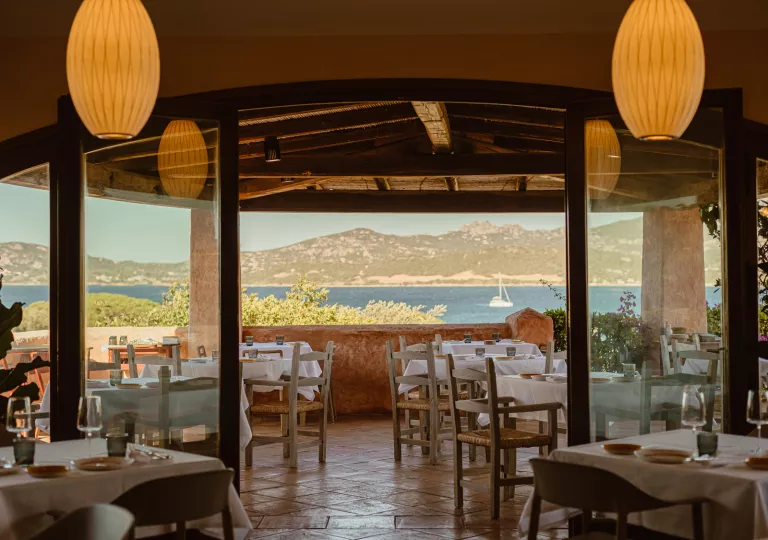 Dining area with a large, glass door leading to an outdoor patio