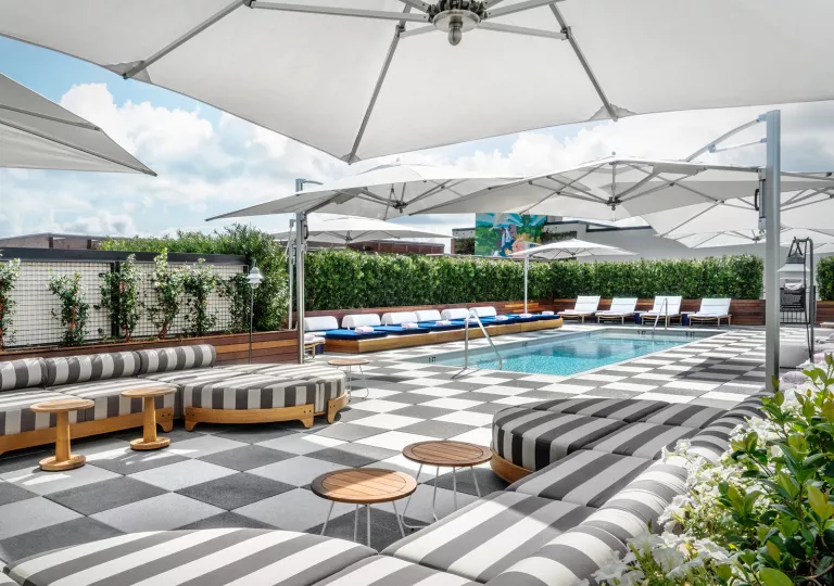 pool deck with lounge furniture and umbrellas