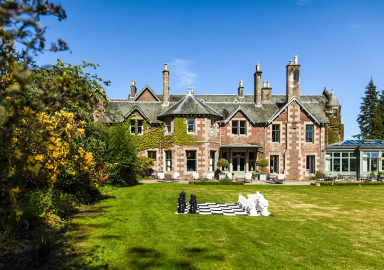 large stone house and expansive lawn