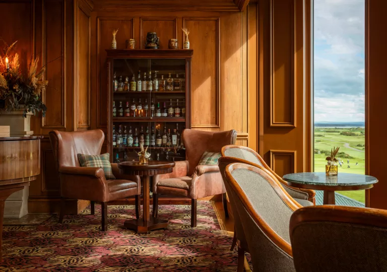 sitting room with dark wood furniture and liquor cabinet
