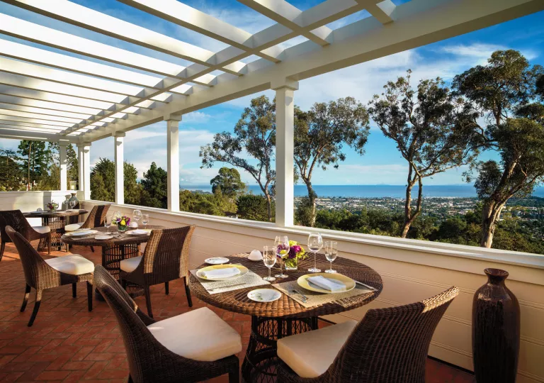 Outdoor dining patio with woven chairs and tables