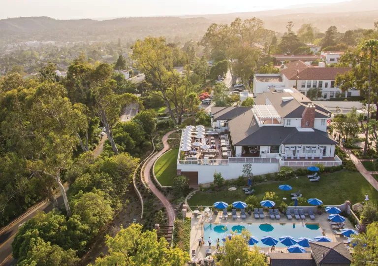 Top view of hotel with outdoor patio and an outdoor pool