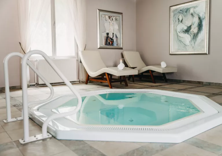 Hot tub next to lounge chairs