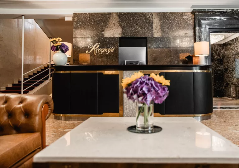 Hotel lobby with front desk and arm chairs