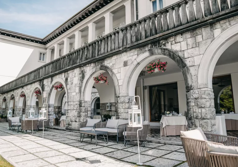 Terrace with lounge chairs and tables under an awning