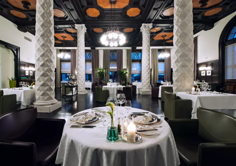 Dining room tables set with glassware in hotel restaurant