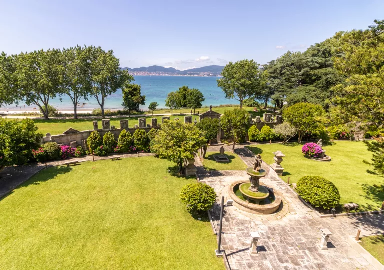 Open grass courtyard with a fountain in the center