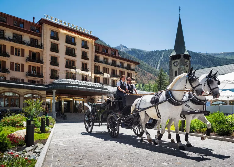 horse drawn carriage out front of hotel zermatterhof