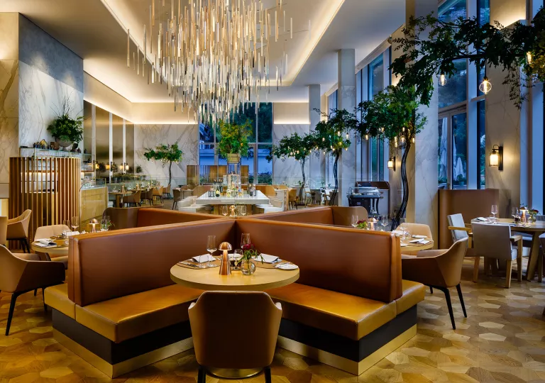 hotel lobby with chairs and large chandelier