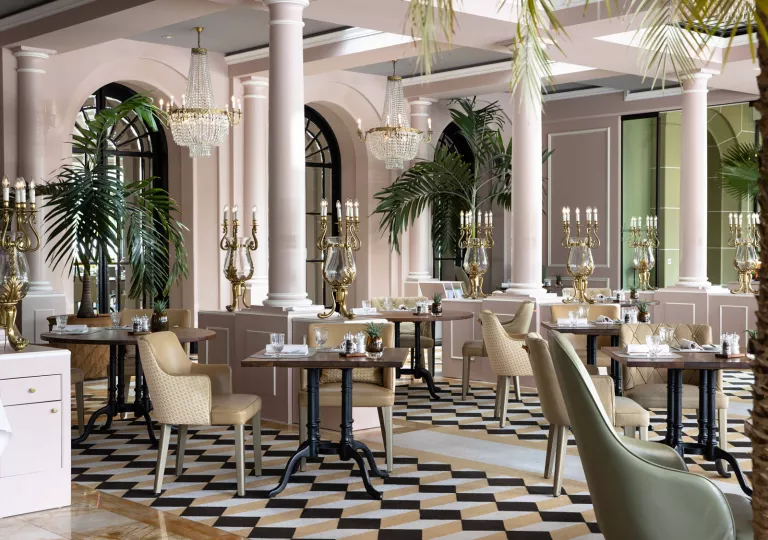 Indoor lounge and dining areas with pink walls and large pillars