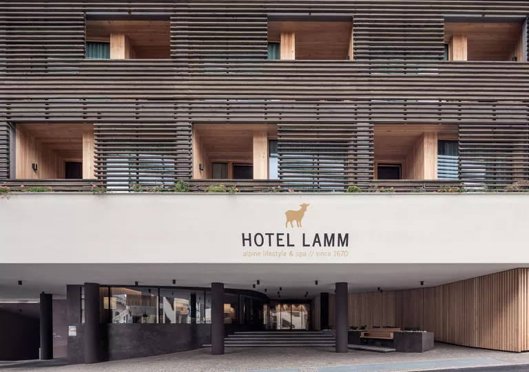 Outdoor view of a hotel sign with rooms and outdoor balconies
