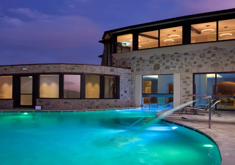 hotel pool lit up at night