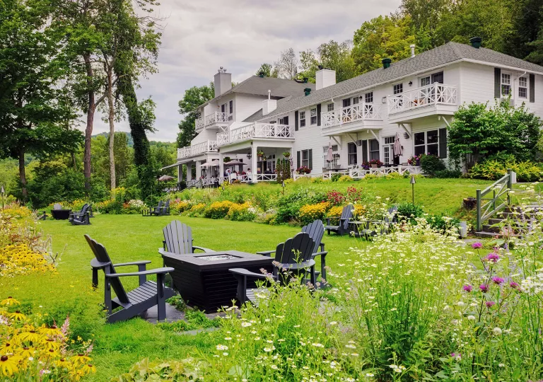 expansive lawn and fire pit outside of manor house