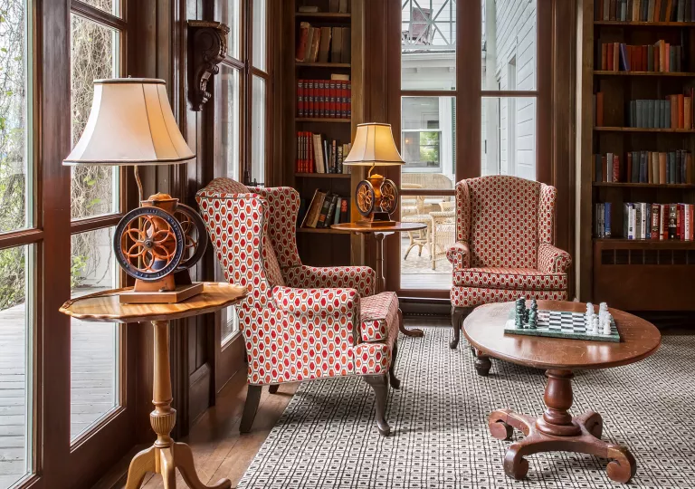 hotel library room with books and chairs