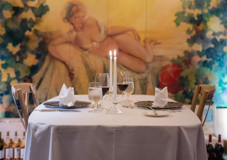 Dining table with two candles and two glasses of wine