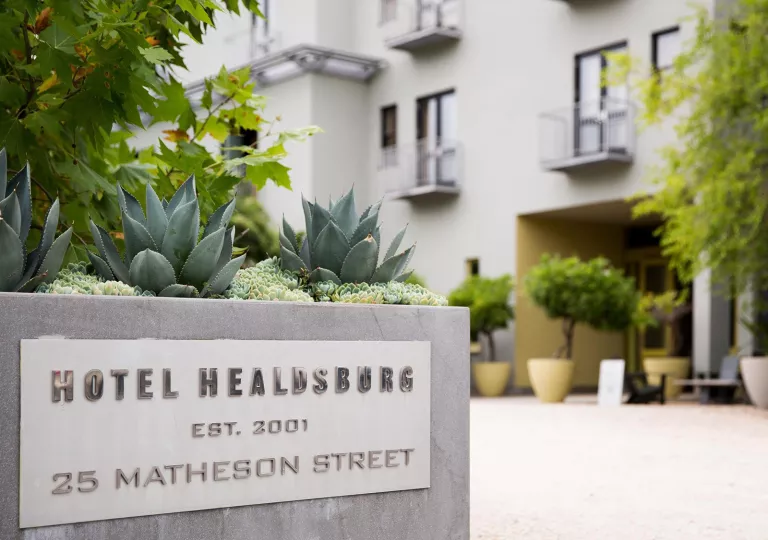Stone hotel sign with cactus on top