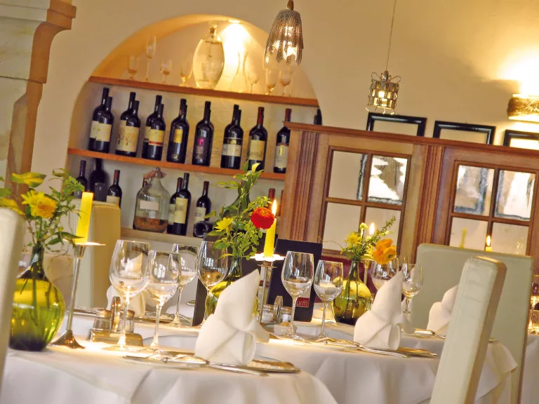 dining room with wine bottles on back wall