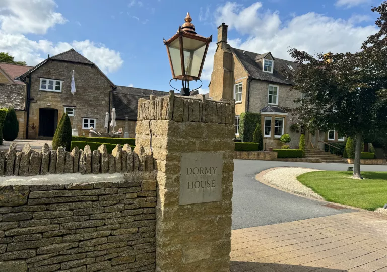 stone gates to a large stone home