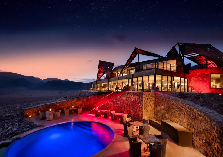 pool and hotel lit up at night