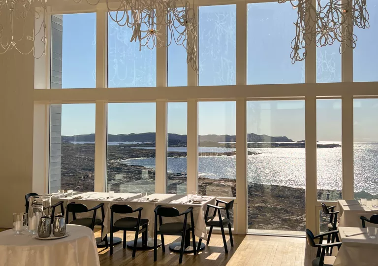 dining room with window overlooking water
