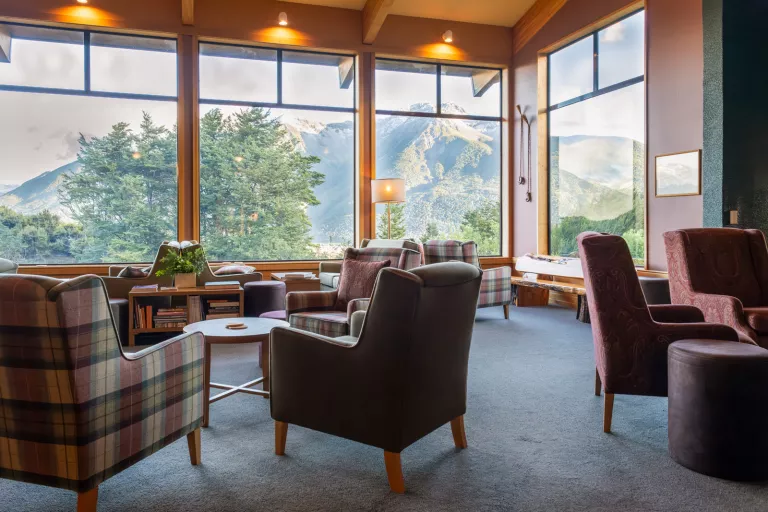 living room with arm chairs and large windows