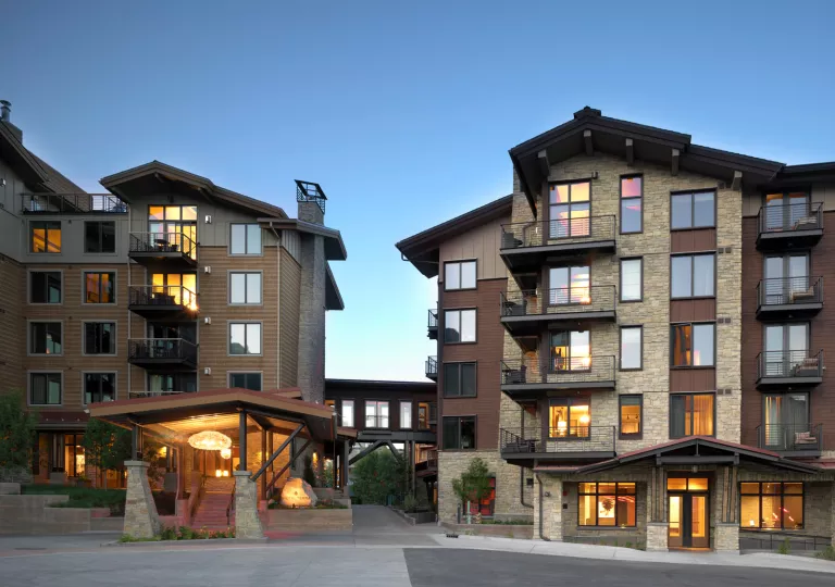 Exterior view of stone hotel building with metal balconies