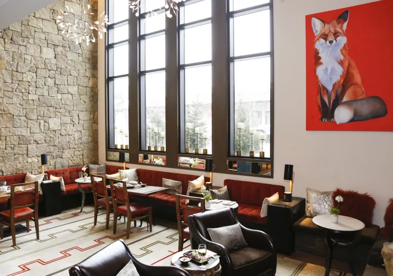 dining room with red couches and large windows