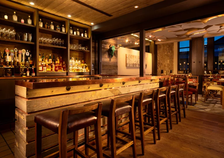 wooden bar with barstools