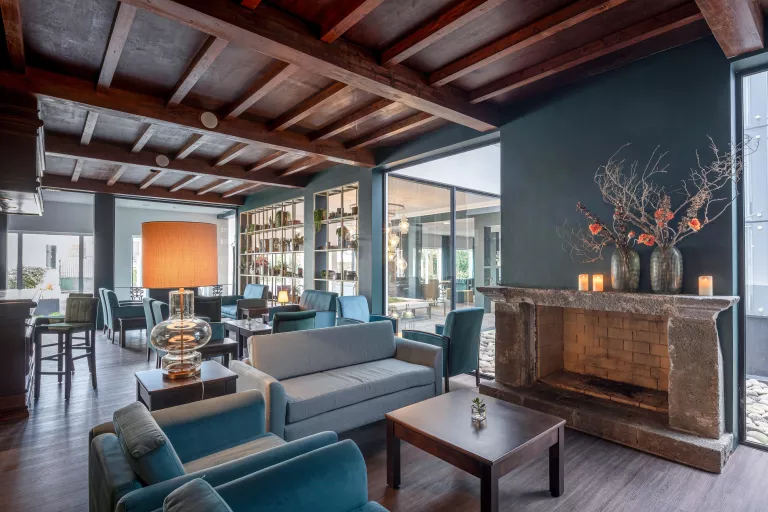 Lobby with cushioned chairs and windows in the background