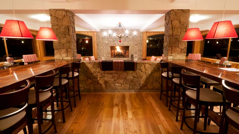 Restaurant with long, wooden tables and tall stools